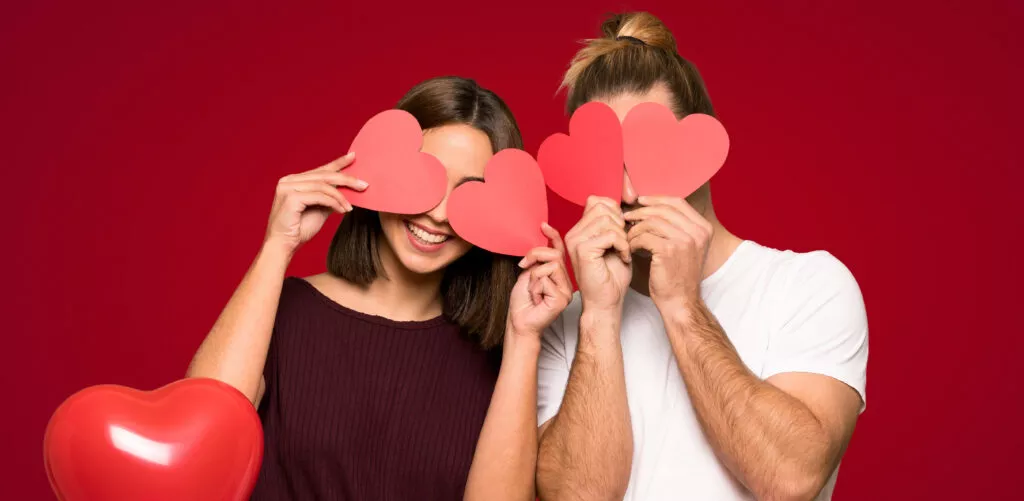 couple valentine day holding heart symbol