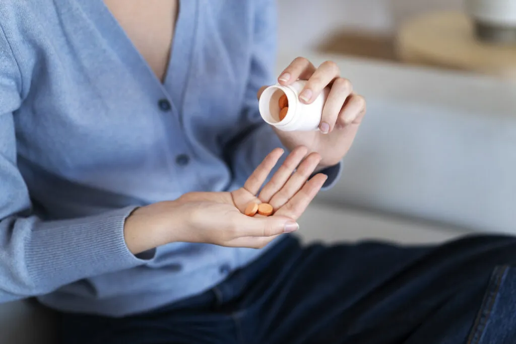 high angle woman holding pills
