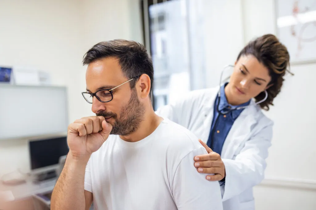 female doctor clinic performs auscultation lungs patient with symptoms coronavirus pneumonia