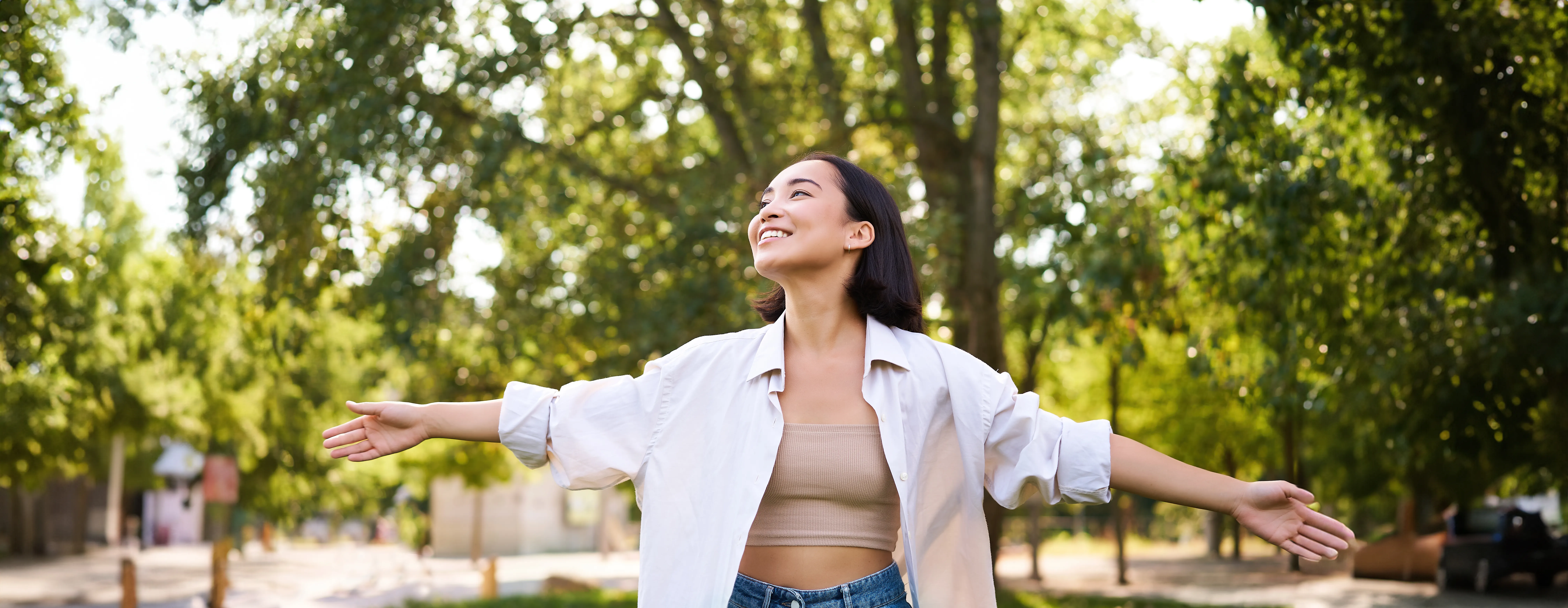 portrait carefree young asian woman dancing park alone enjoying freedom smiling with joy