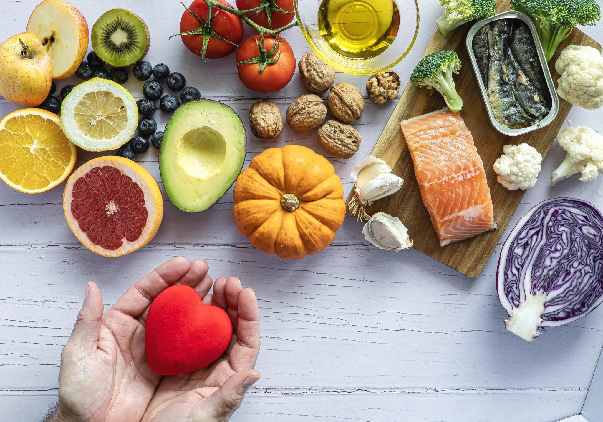 Imagem de alimentos saudáveis com peixes, frutas, legumes e azeite, promovendo uma alimentação nutritiva e equilibrada para uma vida saudável.